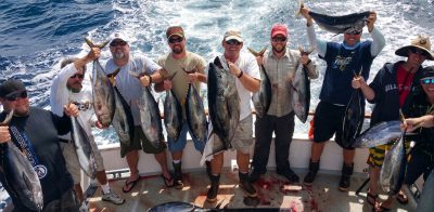 A fun group of Men on a bachelor's party show off their amazing catch at H&M Landing.