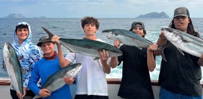 A group of boys holding their paligic catch on the Grande out of H&M Landing.